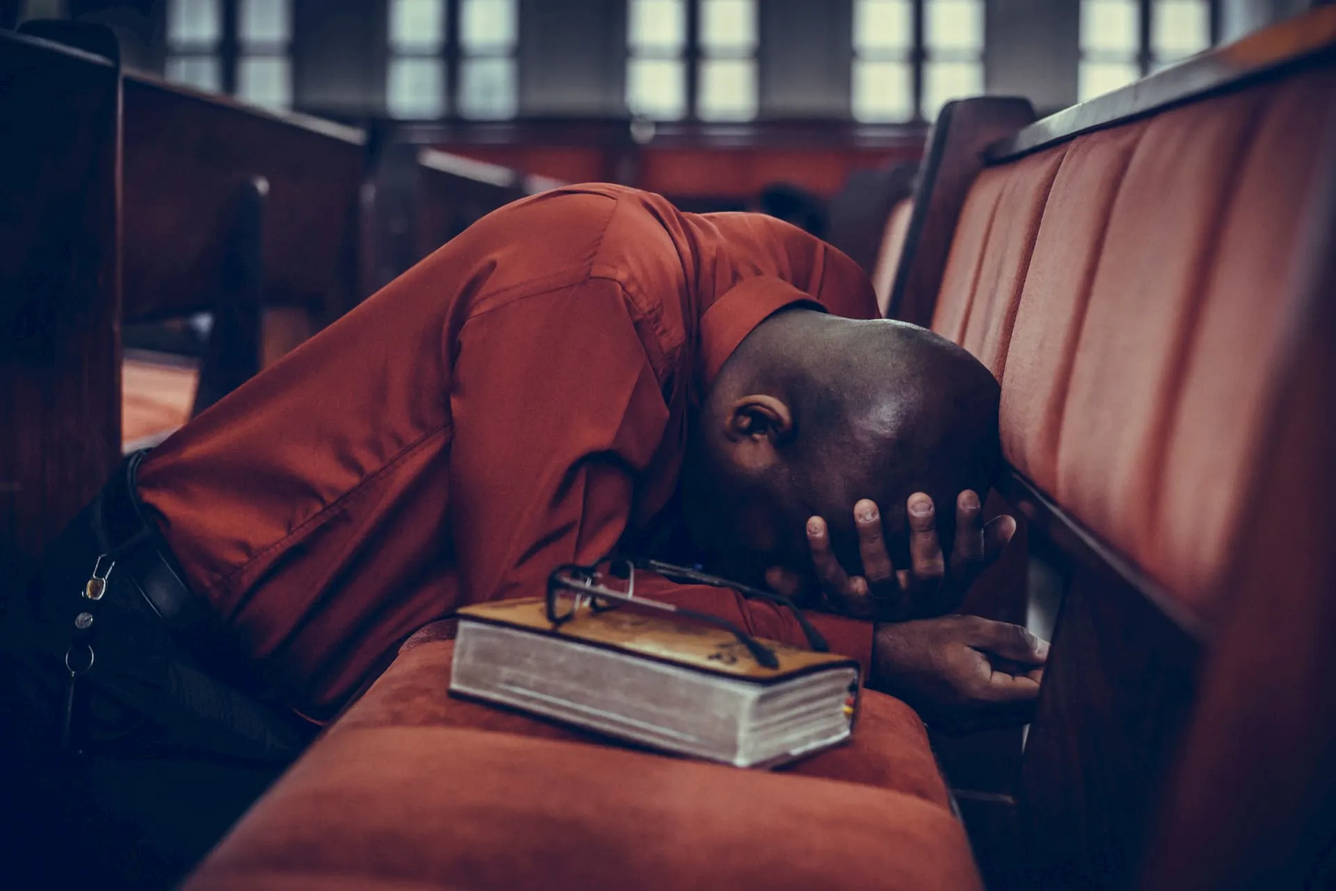 A person in prayer inside church